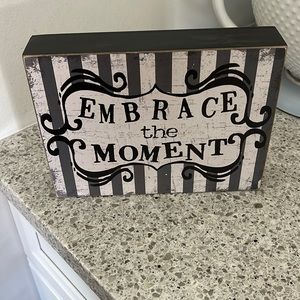 “Embrace the Moment” sign